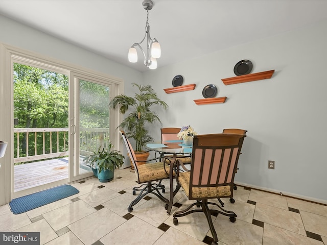dining area featuring an inviting chandelier and baseboards