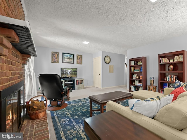 living room featuring a brick fireplace and a textured ceiling