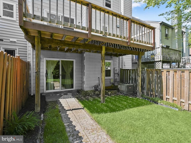 back of house with a yard, central AC unit, a fenced backyard, and a wooden deck