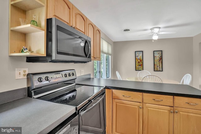 kitchen with open shelves, a peninsula, dark countertops, a ceiling fan, and stainless steel appliances