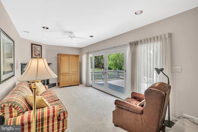 living area featuring recessed lighting, ceiling fan, and light colored carpet