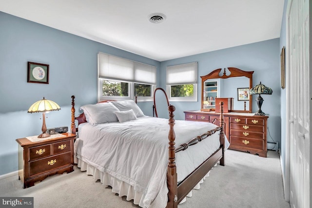 carpeted bedroom with visible vents and baseboards