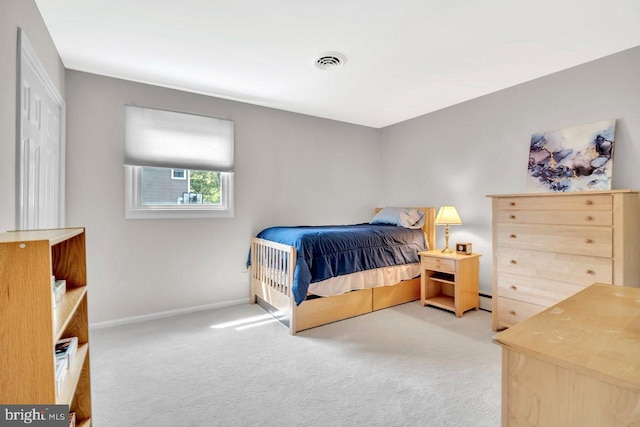 bedroom featuring carpet floors, baseboards, baseboard heating, and visible vents