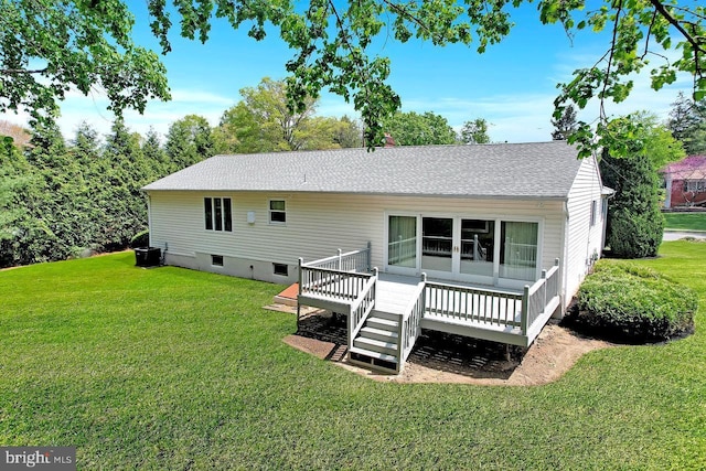 rear view of house featuring roof with shingles, central AC unit, a yard, and a deck