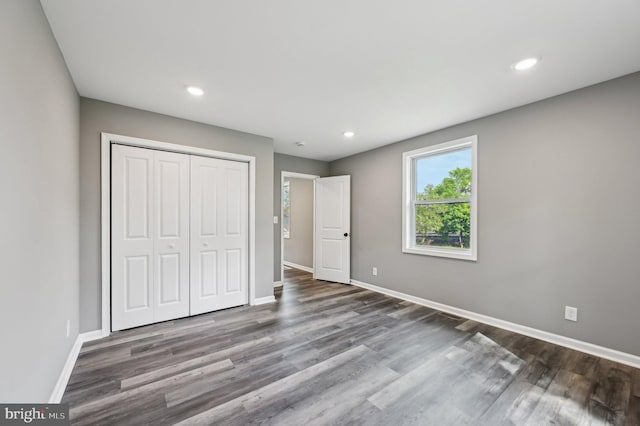 1954 Sponson St, Baltimore, MD 21230 - unfurnished bedroom featuring baseboards, a closet, and wood finished floors