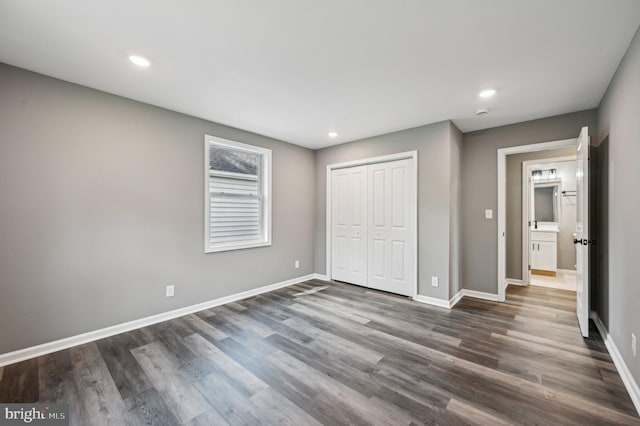 1954 Sponson St, Baltimore, MD 21230 - unfurnished bedroom with baseboards, dark wood-style flooring, a closet, and recessed lighting