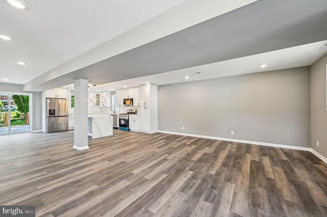 1954 Sponson St, Baltimore, MD 21230 - unfurnished living room with wood finished floors, baseboards, a sink, and recessed lighting
