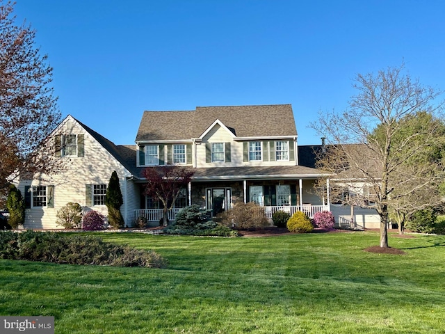 colonial-style house featuring covered porch and a front lawn