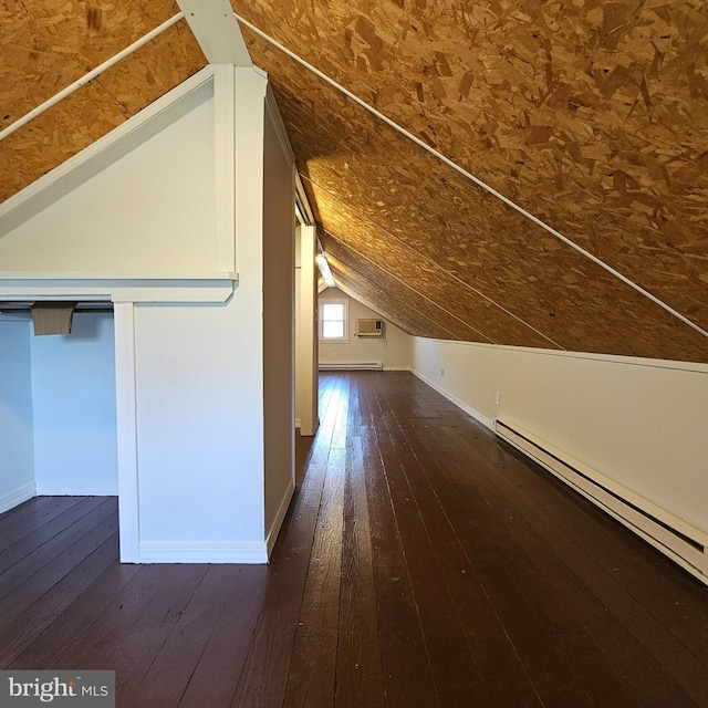 additional living space featuring baseboards, a baseboard heating unit, lofted ceiling, and hardwood / wood-style floors