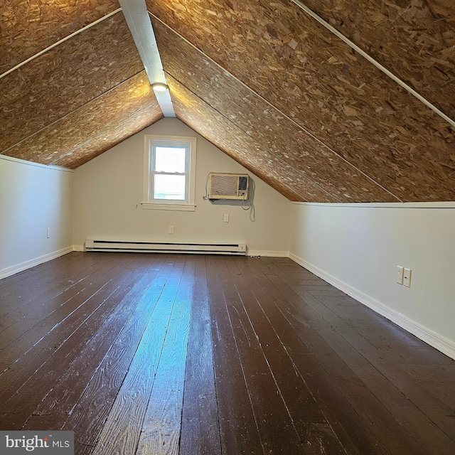 bonus room featuring baseboards, a wall mounted AC, a baseboard heating unit, and dark wood finished floors