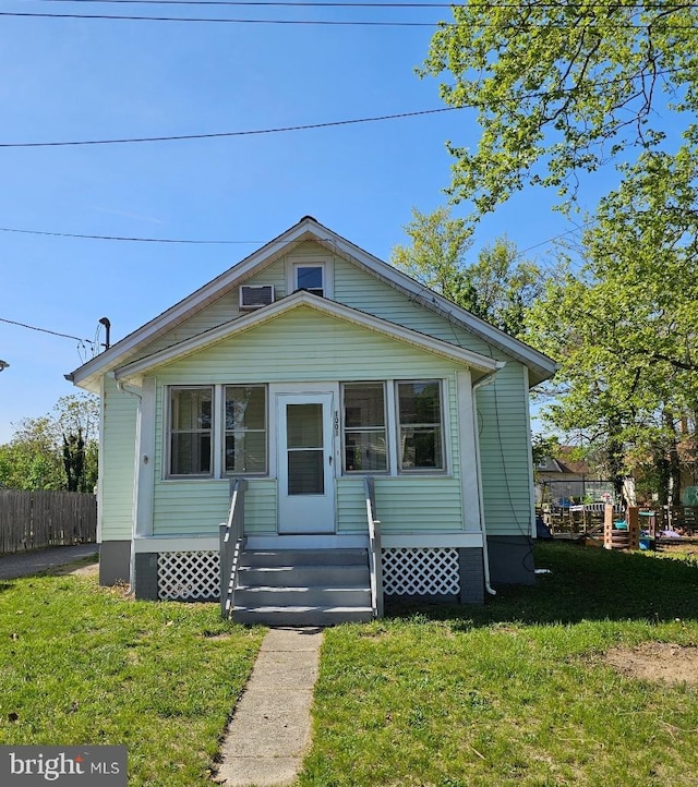 bungalow with fence and a front yard