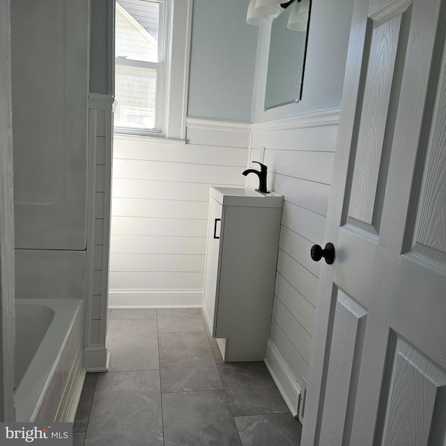 bathroom featuring tile patterned flooring and vanity