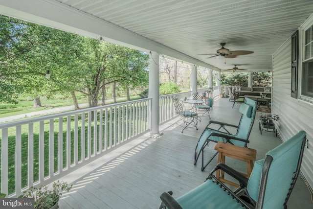 wooden deck featuring ceiling fan and outdoor dining area
