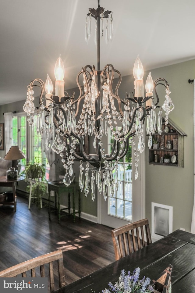 room details with wood finished floors and a notable chandelier
