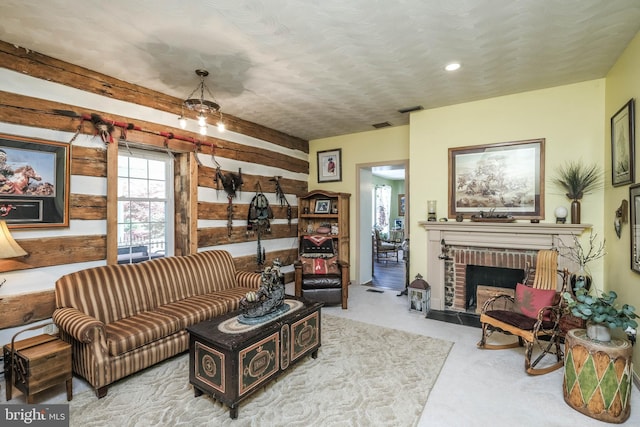 living room featuring carpet flooring, a brick fireplace, recessed lighting, and visible vents