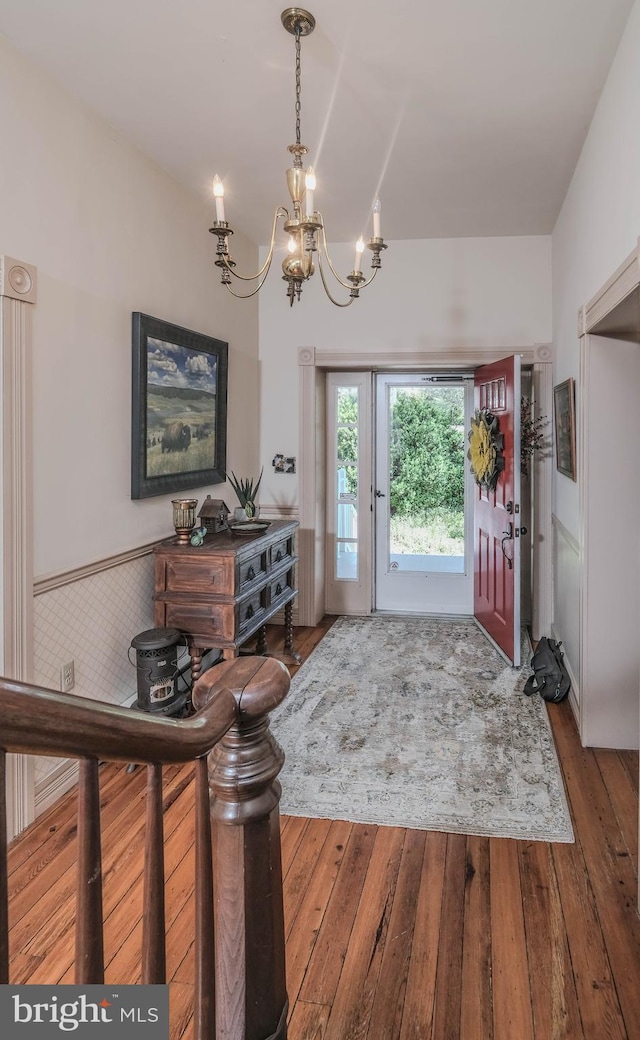 entrance foyer featuring a notable chandelier and hardwood / wood-style floors