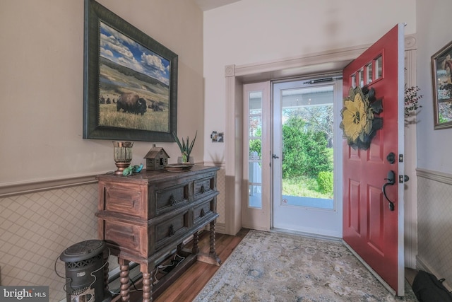 entrance foyer with wainscoting and wood finished floors