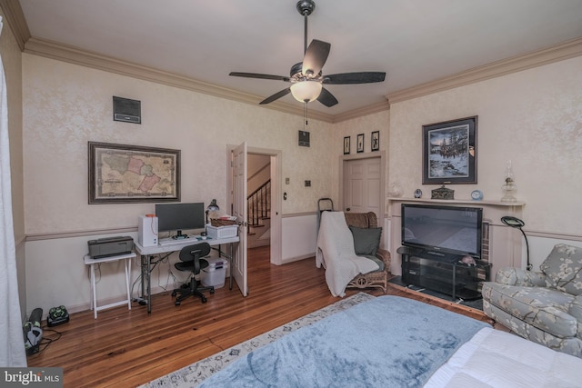 office with crown molding, baseboards, a ceiling fan, and wood finished floors