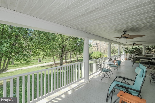 exterior space featuring a ceiling fan, a yard, and a porch