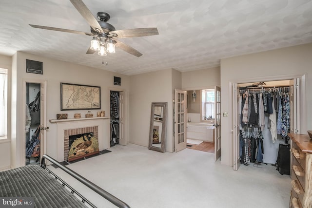 carpeted bedroom with a ceiling fan, a closet, a textured ceiling, and connected bathroom