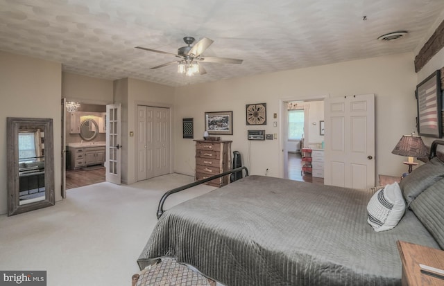 bedroom with a ceiling fan, visible vents, carpet floors, a closet, and connected bathroom