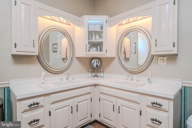 full bathroom with double vanity and a sink