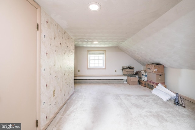 bonus room featuring baseboards, carpet, a baseboard heating unit, and lofted ceiling