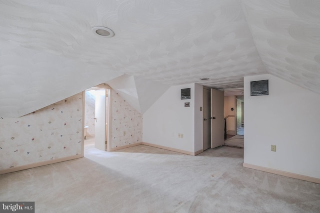 bonus room featuring carpet floors, baseboards, and lofted ceiling