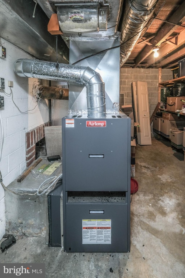 utility room featuring heating unit