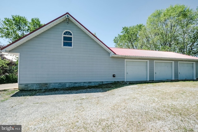 view of side of home with metal roof