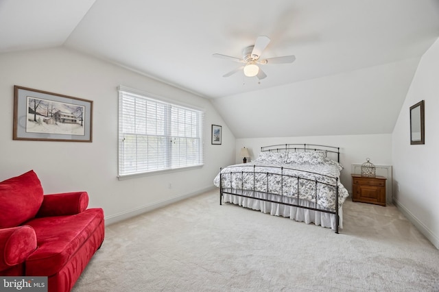 carpeted bedroom featuring baseboards, a ceiling fan, and vaulted ceiling