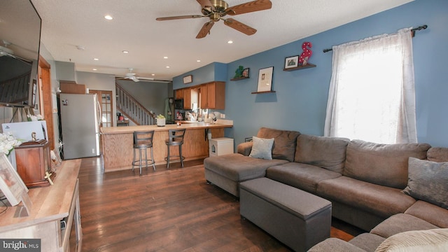 living area featuring recessed lighting, ceiling fan, dark wood-style floors, and stairway