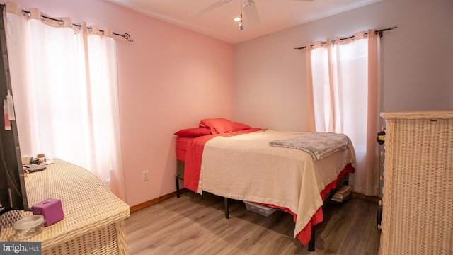 bedroom featuring a ceiling fan and wood finished floors