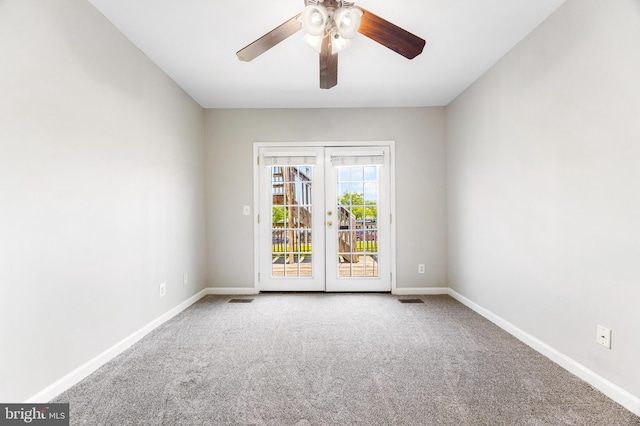 carpeted empty room featuring baseboards, ceiling fan, and french doors
