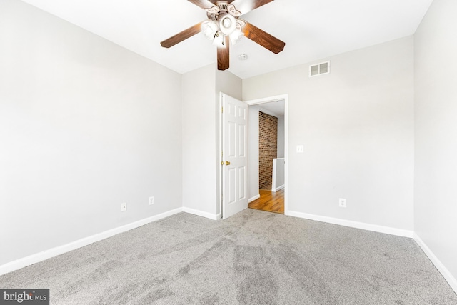 unfurnished bedroom featuring carpet flooring, baseboards, visible vents, and ceiling fan