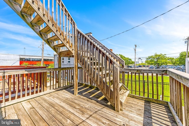 deck with stairs and a yard