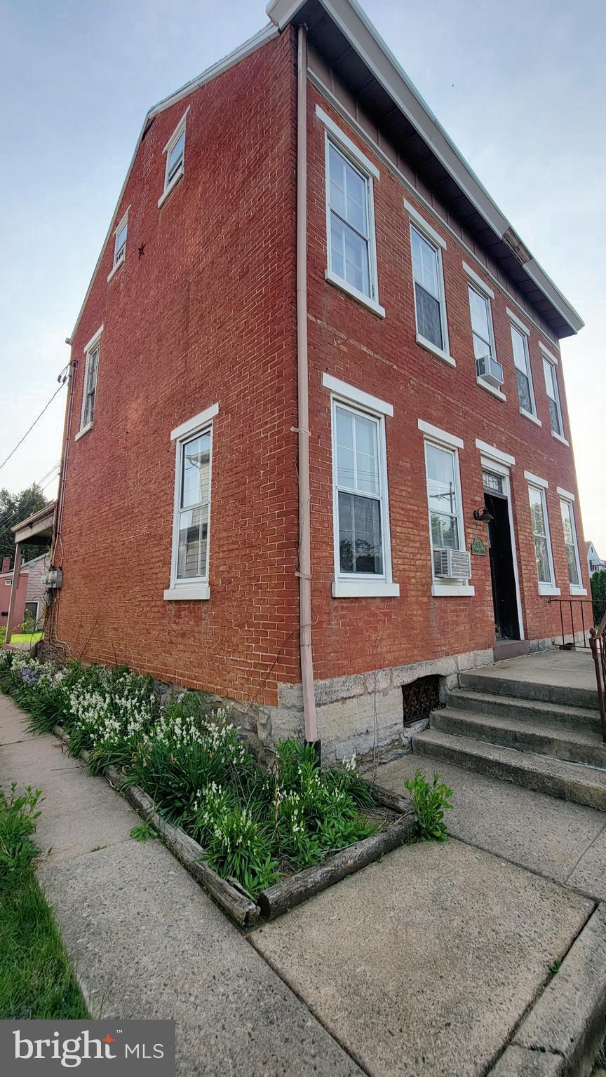exterior space featuring cooling unit and brick siding