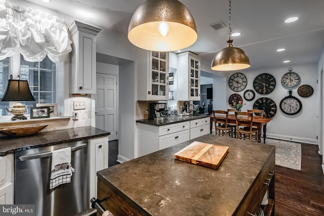 kitchen featuring baseboards, visible vents, dark wood-style floors, and dishwasher