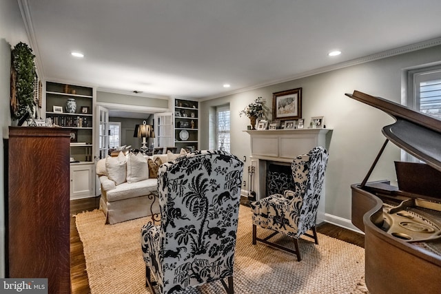living room featuring ornamental molding, recessed lighting, wood finished floors, and a wealth of natural light