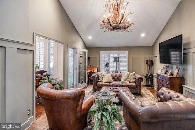 living area featuring recessed lighting, high vaulted ceiling, a chandelier, and wood finished floors