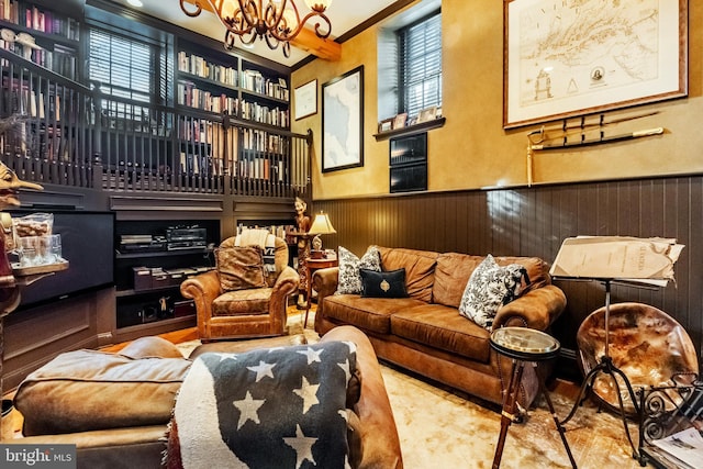 interior space featuring an inviting chandelier, wainscoting, and wooden walls