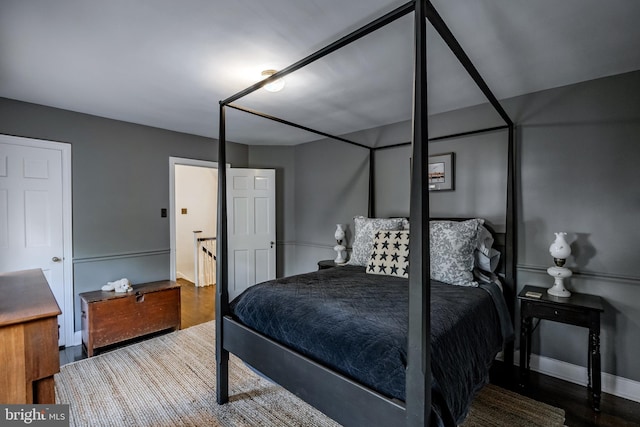 bedroom with baseboards and wood finished floors