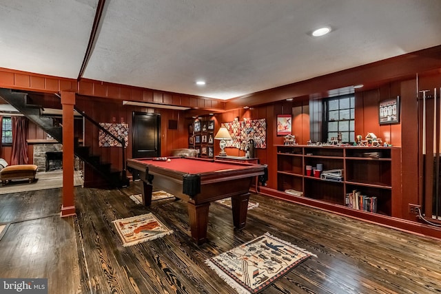 game room featuring wood walls, a healthy amount of sunlight, and hardwood / wood-style floors