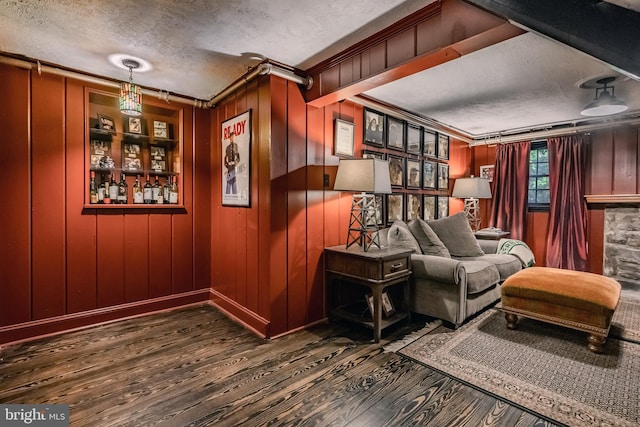 sitting room featuring crown molding, a textured ceiling, and wood finished floors