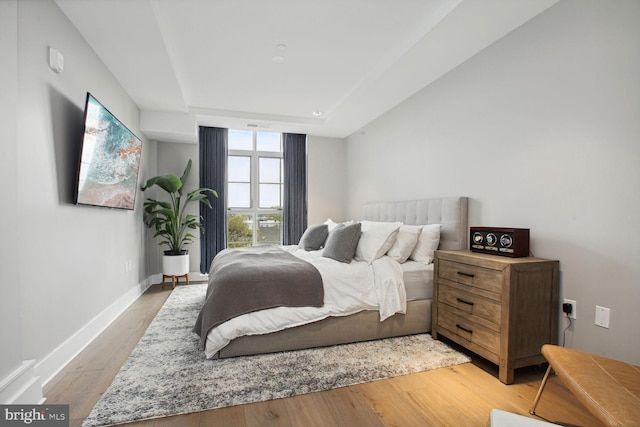 bedroom featuring baseboards and light wood-style floors