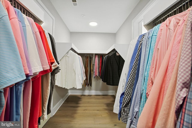 walk in closet featuring wood finished floors and visible vents