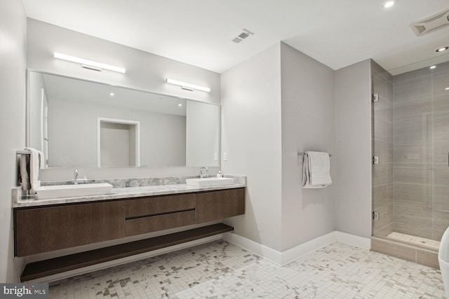 full bath with visible vents, a sink, baseboards, and a shower stall
