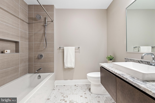 bathroom featuring shower / washtub combination, vanity, baseboards, tile patterned floors, and toilet