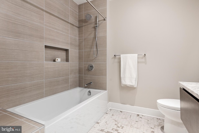 bathroom with vanity, shower / bathtub combination, toilet, tile patterned floors, and baseboards