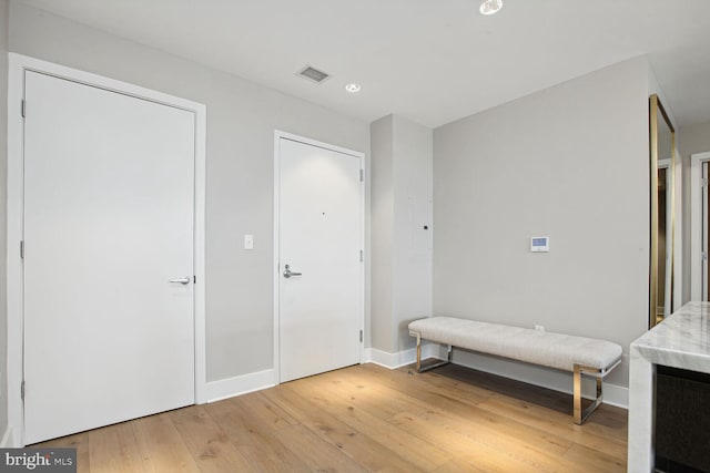 entrance foyer with recessed lighting, baseboards, light wood finished floors, and visible vents
